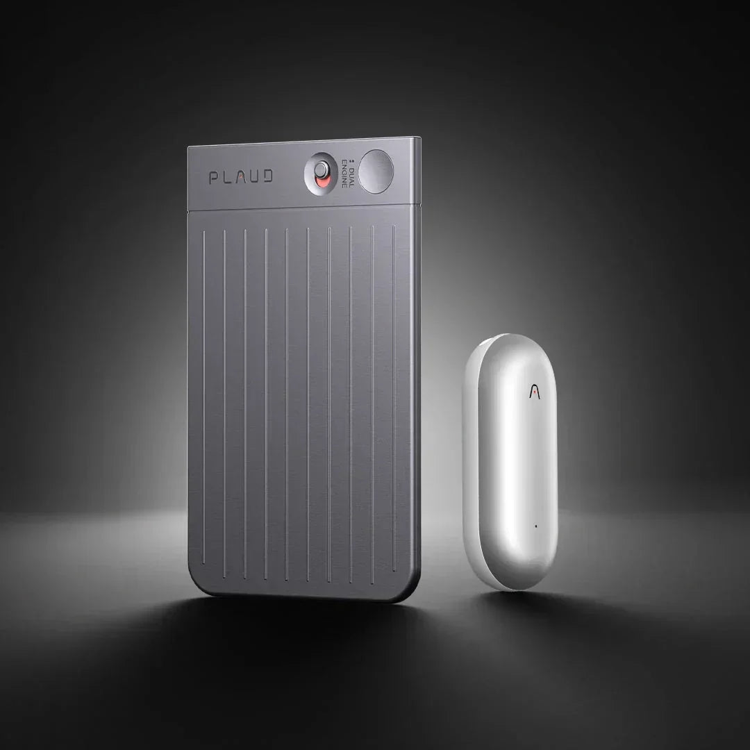 Gray Plaud Note Pro and silver Plaud NotePin AI voice recorders on a dark background.
