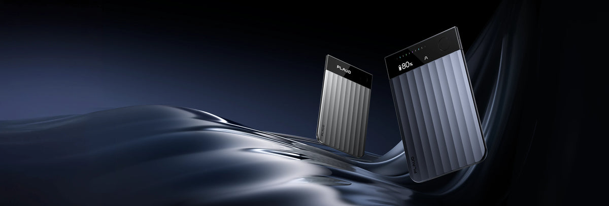 Silver and blue Plaud Note Pro recorders with ribbed bodies and top display screens on a dark fluid background.